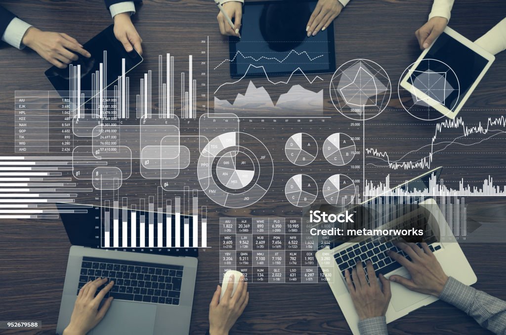 A confident financial advisor explains wealth protection strategies to a client, with graphs and charts showing inflation trends in the background.
